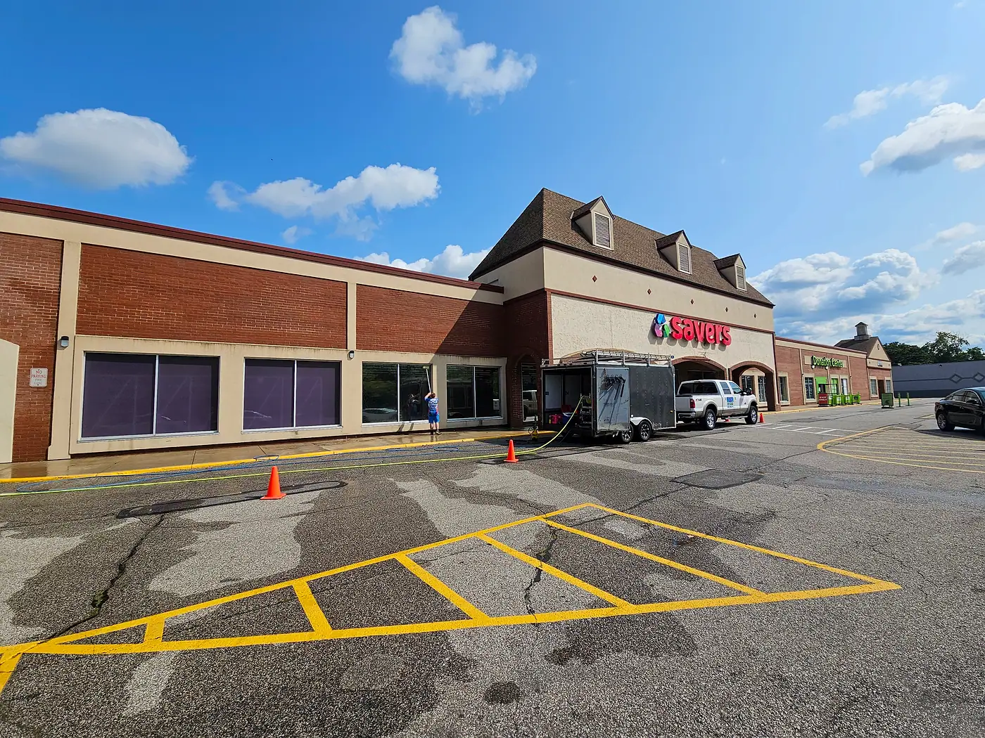 Shopping plaza storefront with a freshly cleaned parking lot and painted lines