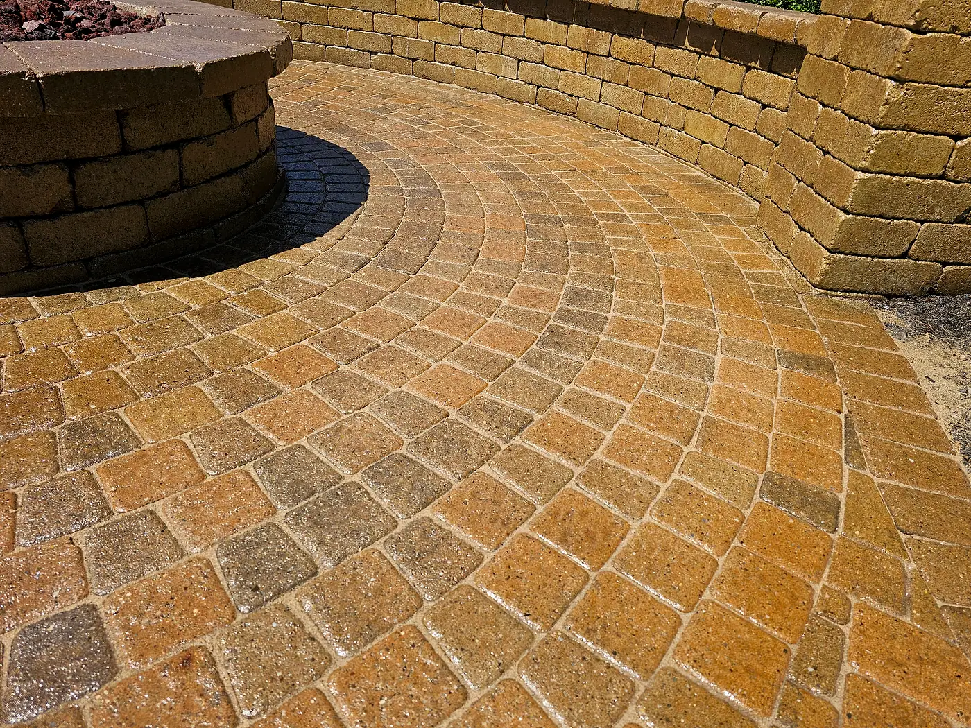Warm-toned paver circle and seat wall after cleaning