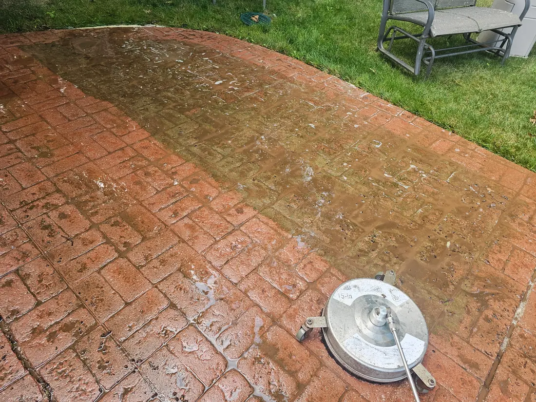 Before: Red stamped concrete patio before and after cleaning