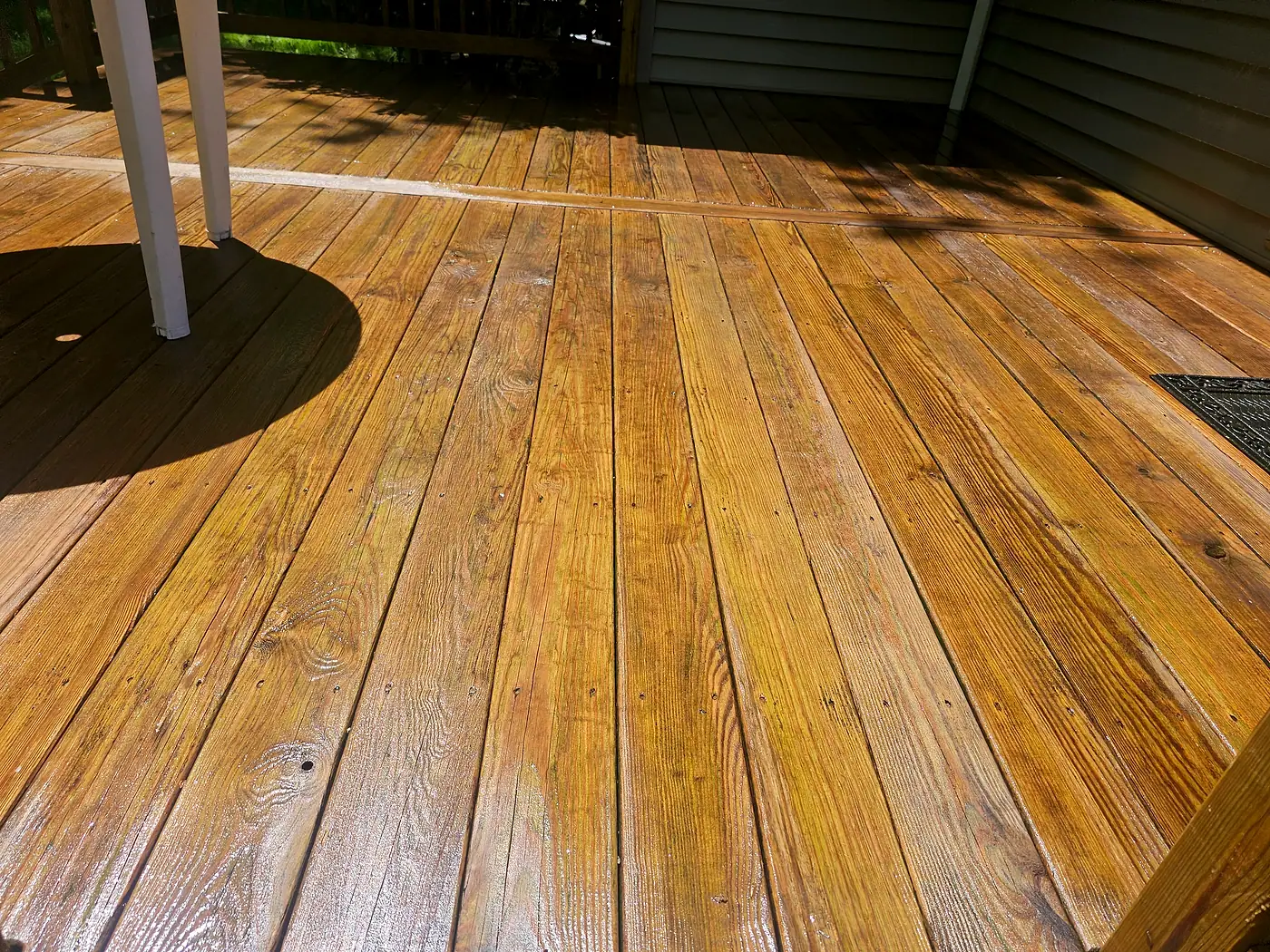 Close view of a clean stained deck floor in the sun